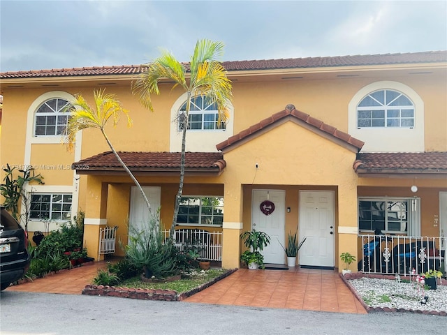 view of front of home with a tile roof and stucco siding