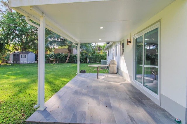 view of patio featuring a shed