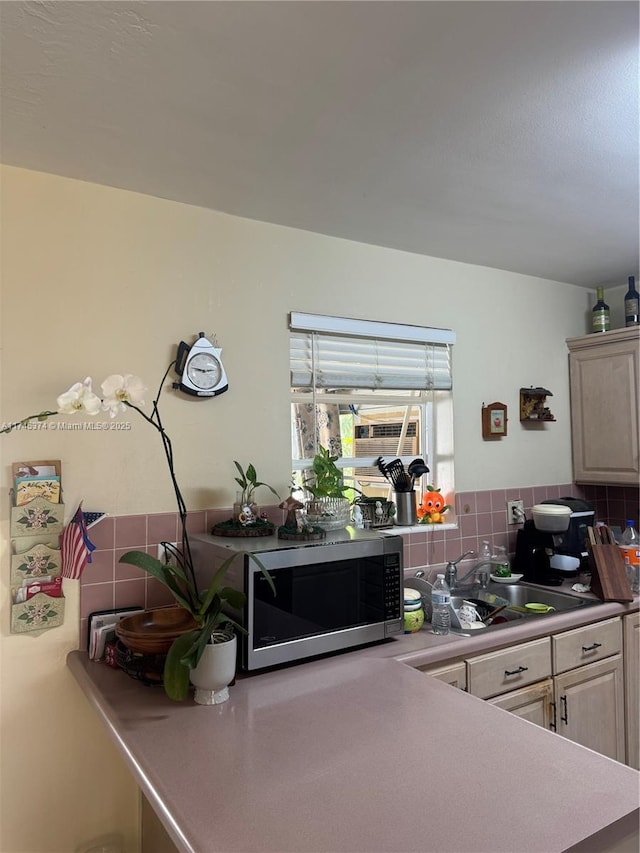 kitchen with cooling unit, sink, and tasteful backsplash