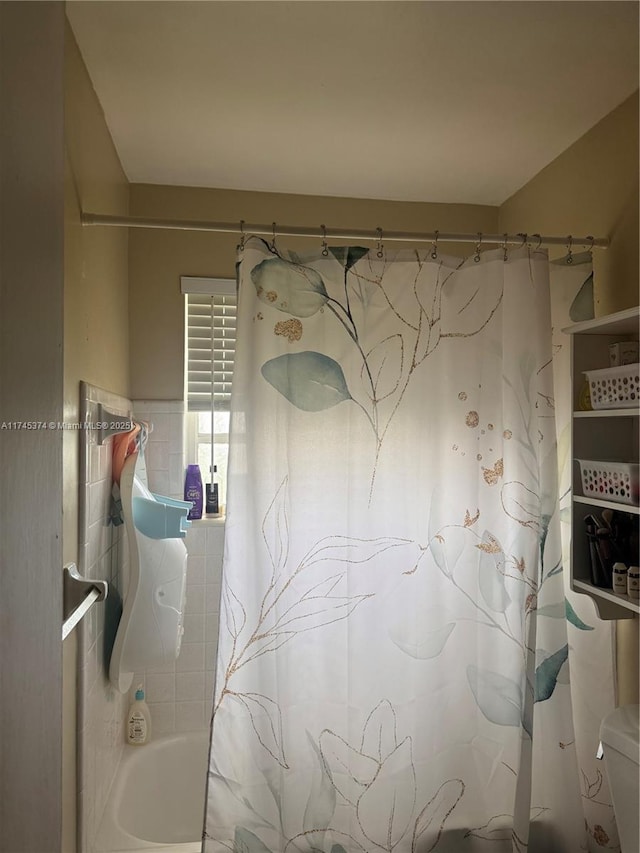 bathroom with shower / bath combination with curtain