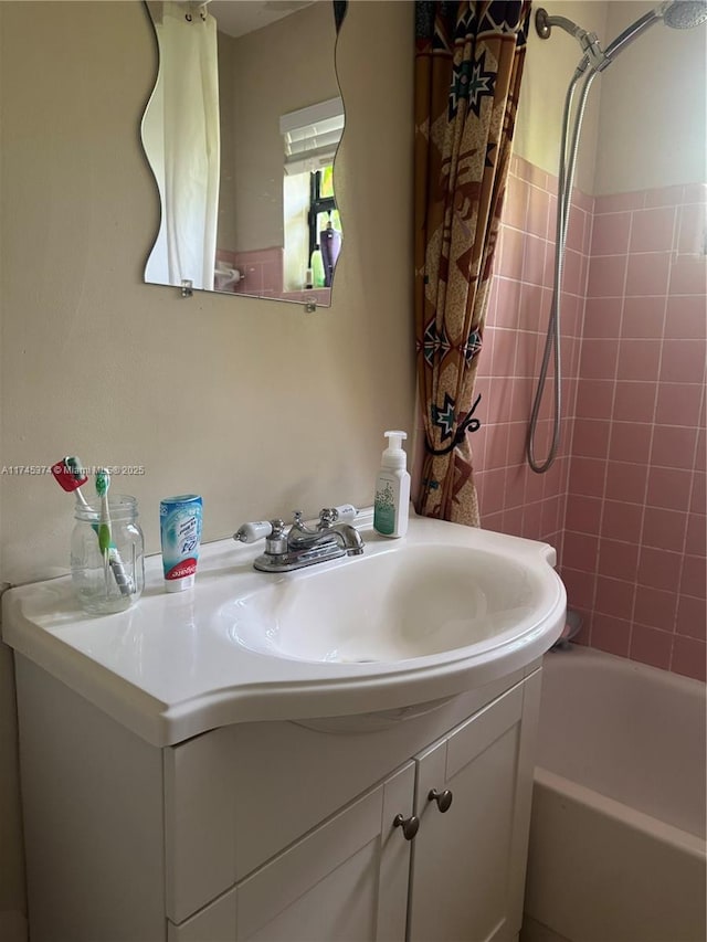 bathroom featuring shower / bath combo with shower curtain and vanity