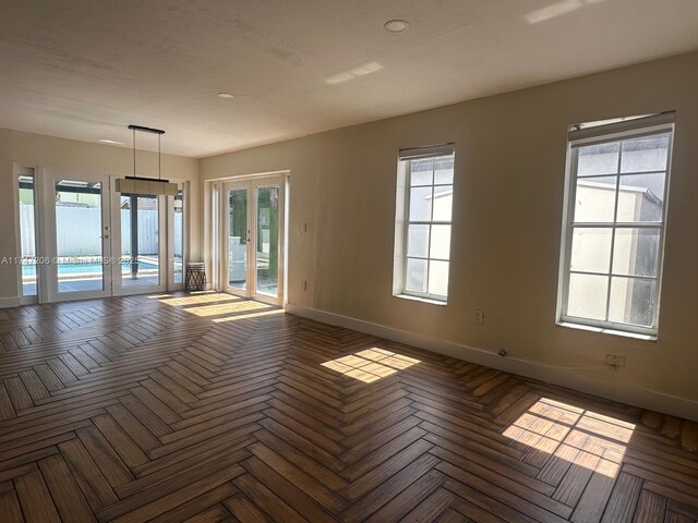 13926 SW 164th St, Miami, FL 33177 - empty room featuring french doors, baseboards, and healthy amount of natural light