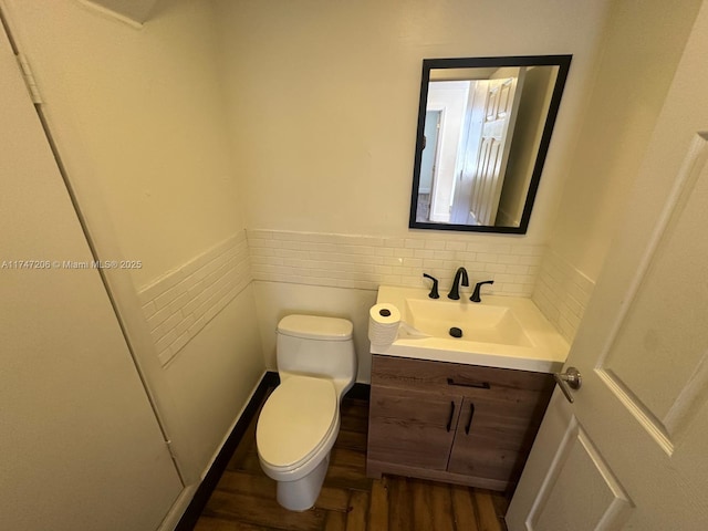 13926 SW 164th St, Miami, FL 33177 - half bathroom featuring wood finished floors, toilet, vanity, and wainscoting