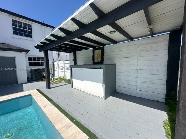 13926 SW 164th St, Miami, FL 33177 - wooden terrace featuring central AC unit and an outdoor pool