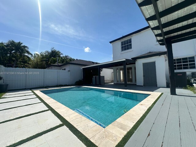 13926 SW 164th St, Miami, FL 33177 - view of swimming pool with cooling unit, fence, and a patio