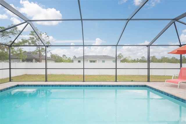 view of pool featuring a lawn, a fenced in pool, a fenced backyard, a lanai, and a patio area