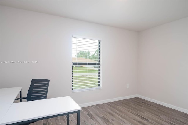 home office featuring baseboards and wood finished floors