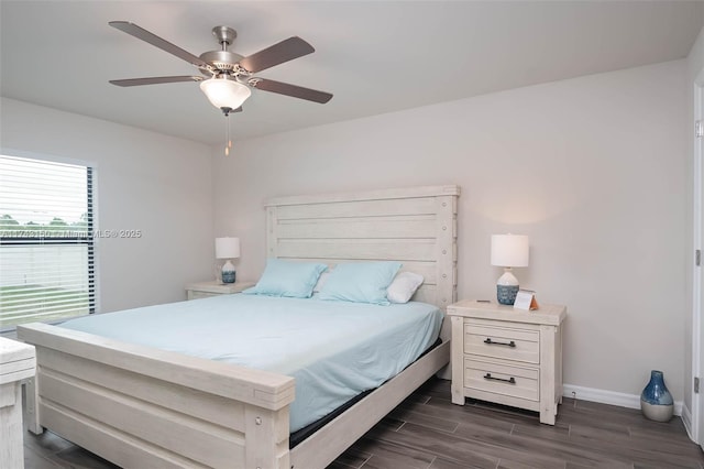 bedroom with wood finish floors, a ceiling fan, and baseboards