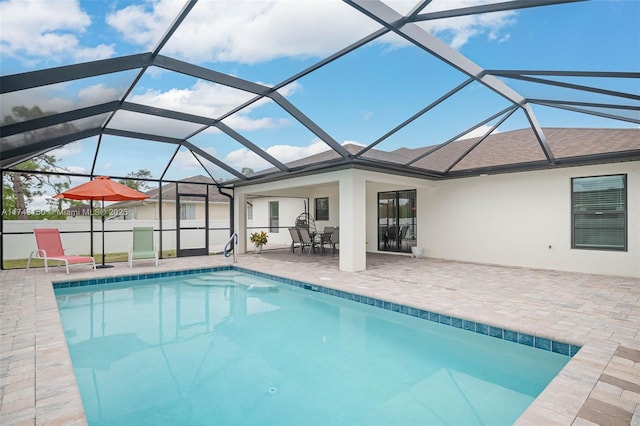 outdoor pool with a lanai and a patio area