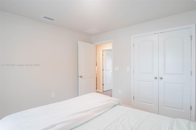 bedroom featuring a closet and visible vents