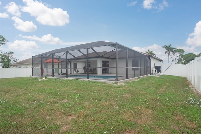 rear view of house with a fenced in pool, a patio, a fenced backyard, a lanai, and a yard