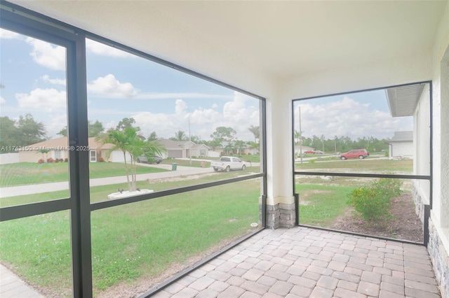 unfurnished sunroom featuring a residential view