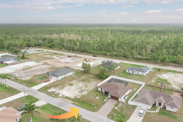 birds eye view of property featuring a wooded view