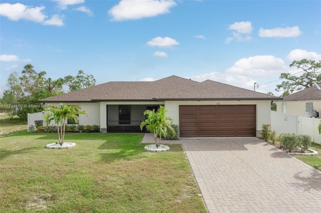 single story home with decorative driveway, an attached garage, fence, and stucco siding