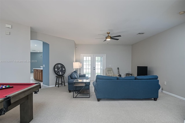 living room featuring ceiling fan, pool table, french doors, and light carpet