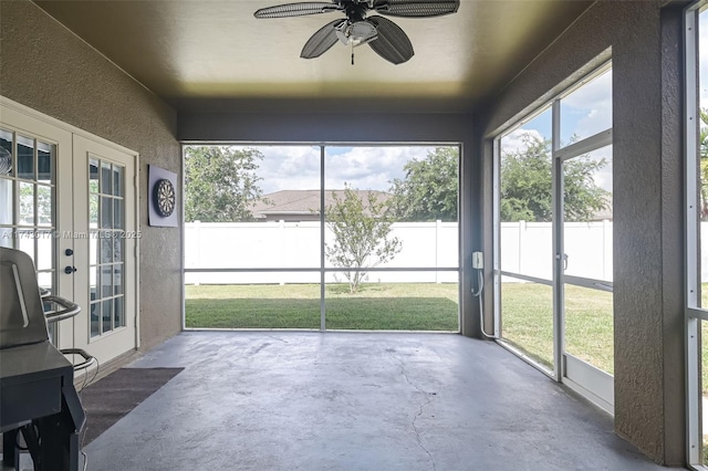 unfurnished sunroom with french doors and ceiling fan