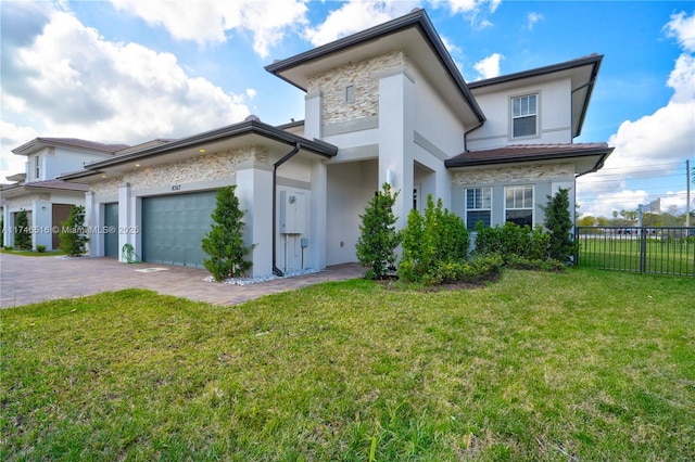 view of front of home with a front lawn and a garage