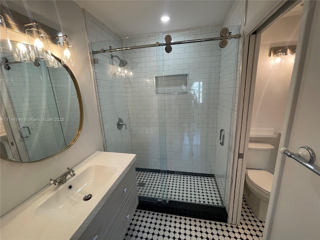 bathroom with vanity, toilet, and walk in shower