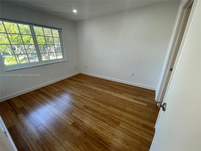 unfurnished room with dark hardwood / wood-style floors