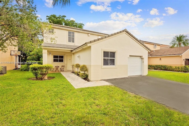 back of property featuring stucco siding, a lawn, a tile roof, aphalt driveway, and an attached garage