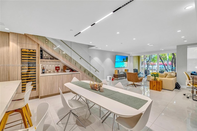 tiled dining space featuring wine cooler and bar