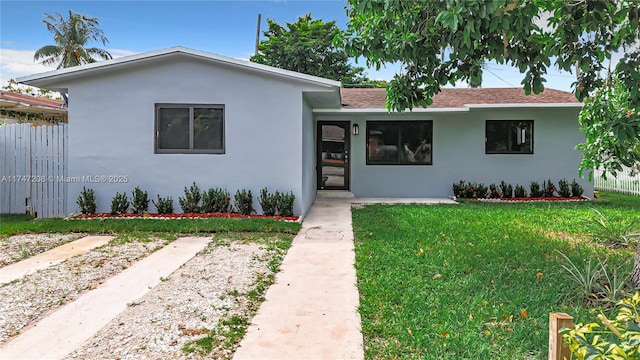 single story home featuring fence, a front lawn, and stucco siding