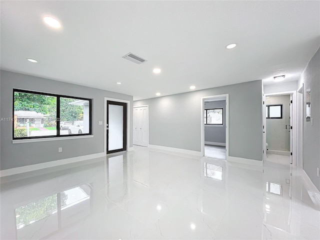 unfurnished room featuring marble finish floor, baseboards, visible vents, and recessed lighting