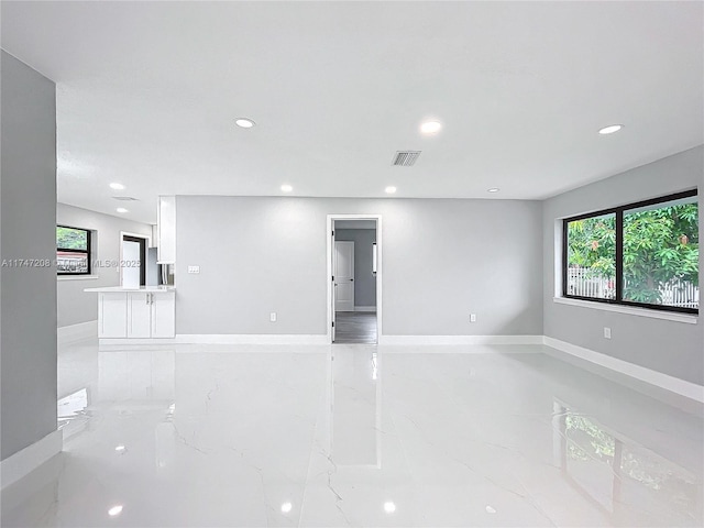 empty room with baseboards, marble finish floor, visible vents, and recessed lighting