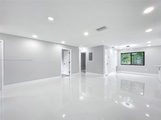 spare room featuring marble finish floor, visible vents, baseboards, and recessed lighting