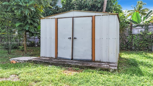 view of shed featuring fence