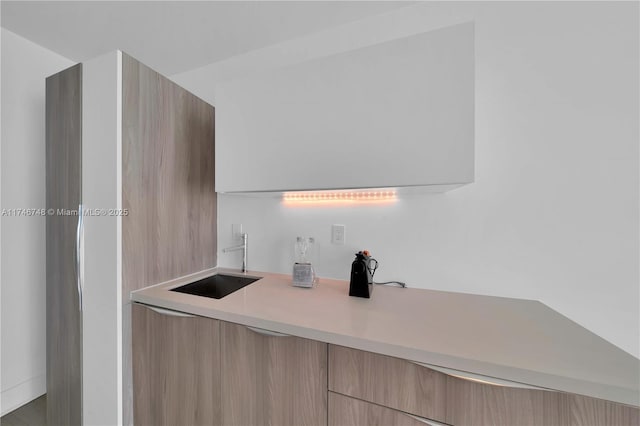 kitchen with sink and light brown cabinetry