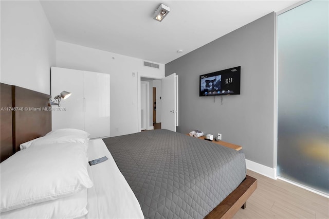 bedroom with light wood-type flooring