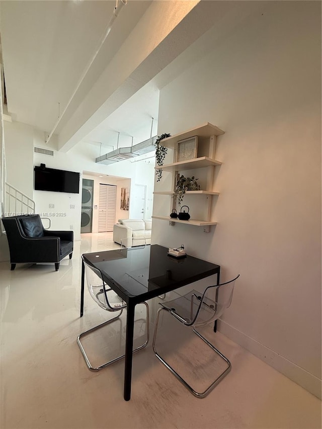 playroom featuring concrete flooring and beamed ceiling