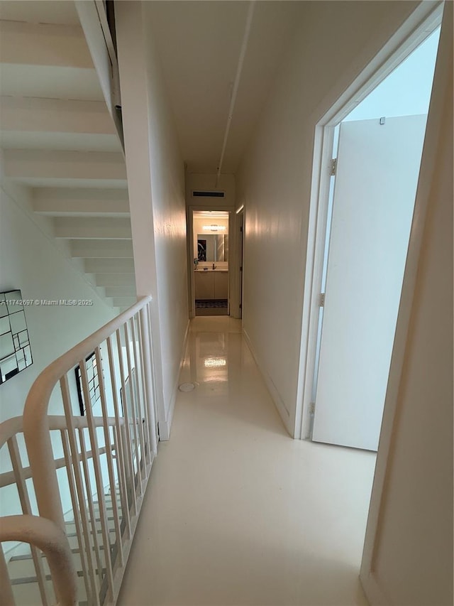 hallway with concrete flooring