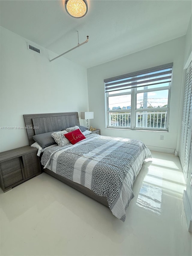 bedroom featuring concrete floors