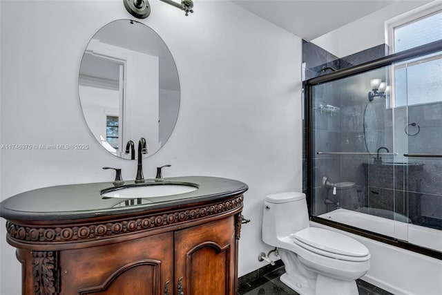 full bathroom featuring bath / shower combo with glass door, vanity, and toilet