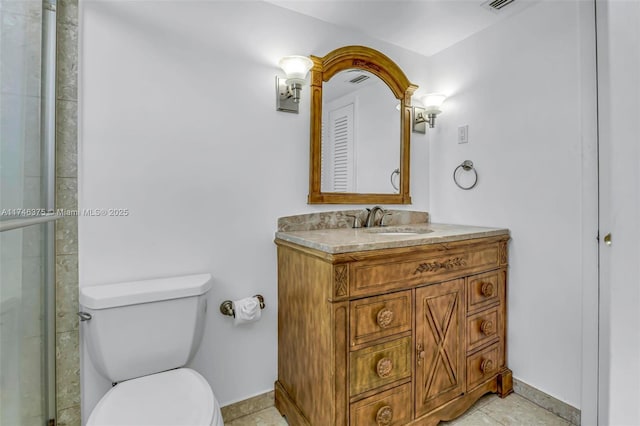 bathroom with vanity, toilet, and a shower with door