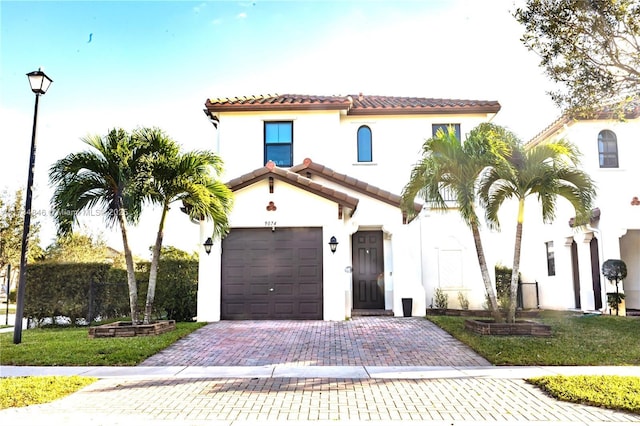 mediterranean / spanish-style house with a garage