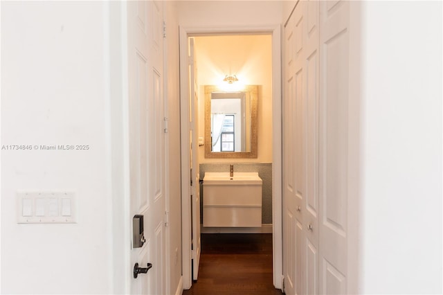 corridor with sink and dark hardwood / wood-style floors