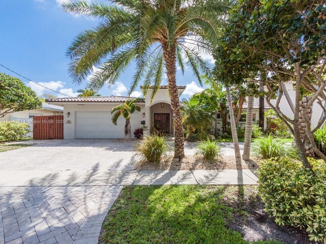 mediterranean / spanish home featuring a garage