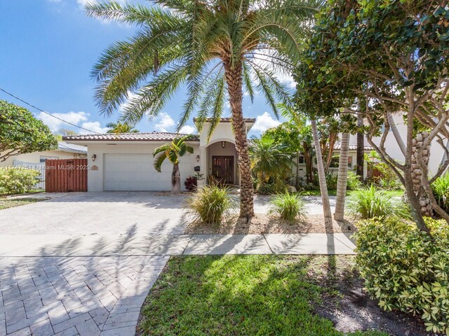 mediterranean / spanish home featuring a garage