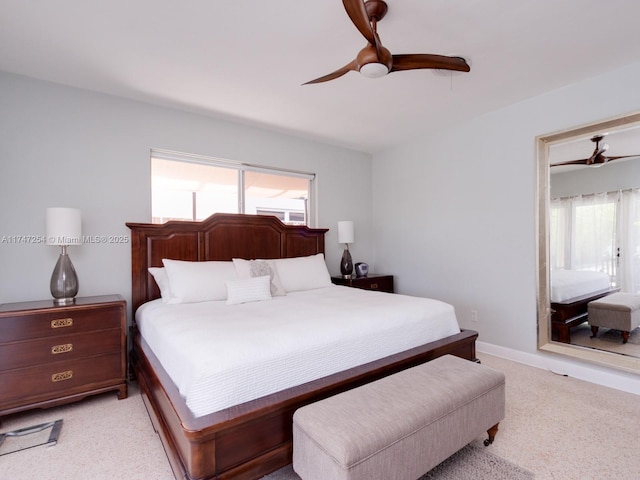 bedroom featuring multiple windows, light carpet, and ceiling fan