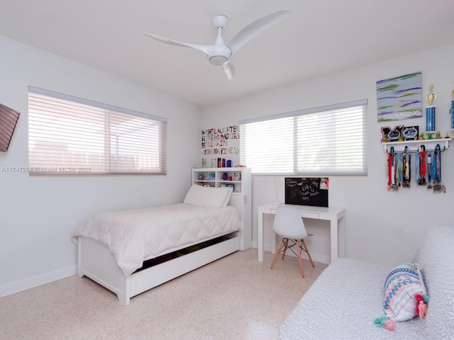 bedroom featuring multiple windows and ceiling fan