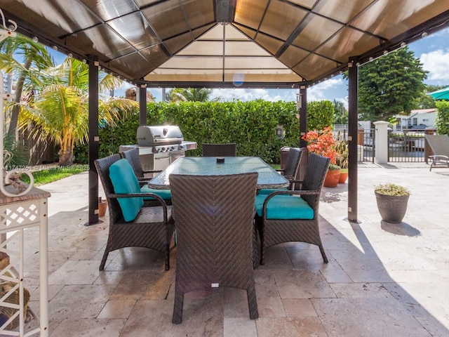 view of patio with area for grilling and a gazebo