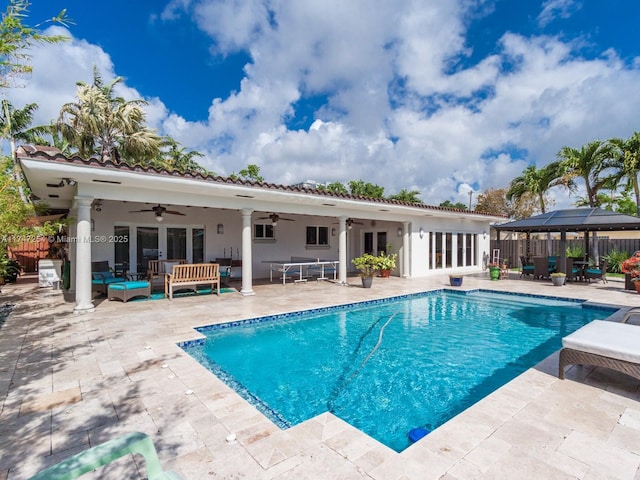 view of swimming pool featuring an outdoor hangout area, ceiling fan, a patio area, and a gazebo