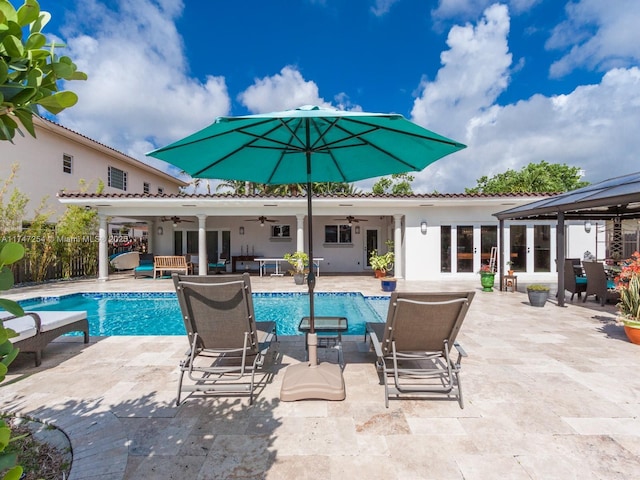 view of swimming pool featuring an outdoor living space, ceiling fan, a patio area, and french doors
