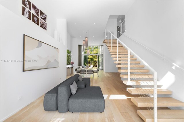 335 W 46th St, Miami Beach, FL 33140 - stairs with a towering ceiling and hardwood / wood-style floors