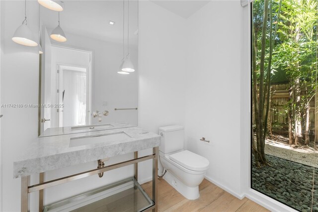 335 W 46th St, Miami Beach, FL 33140 - bathroom featuring toilet and wood-type flooring