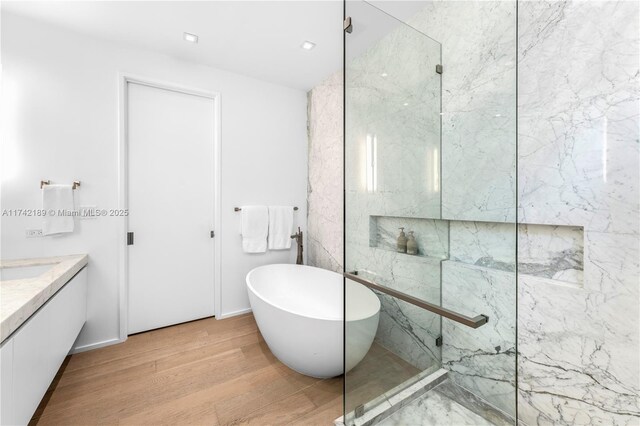 335 W 46th St, Miami Beach, FL 33140 - bathroom featuring hardwood / wood-style flooring, vanity, and independent shower and bath