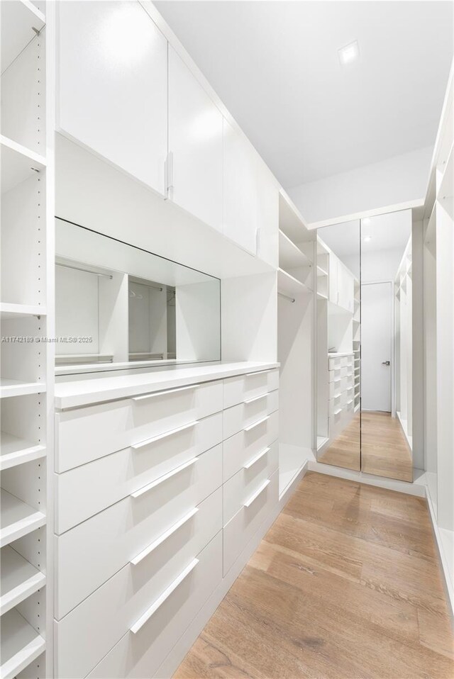 335 W 46th St, Miami Beach, FL 33140 - walk in closet featuring light hardwood / wood-style floors